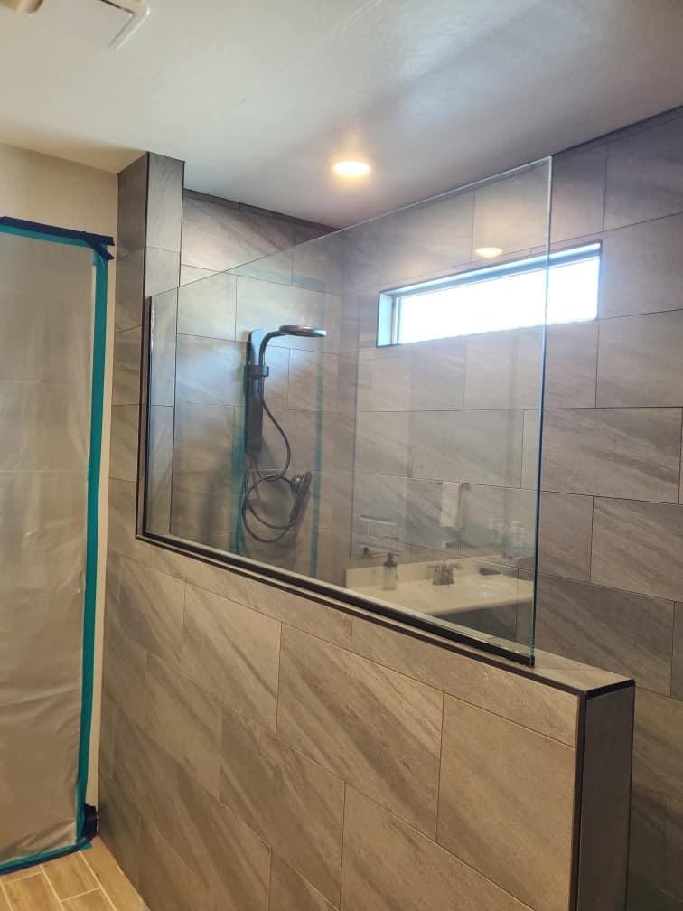 Modern bathroom design with frameless glass shower and stone vanity
