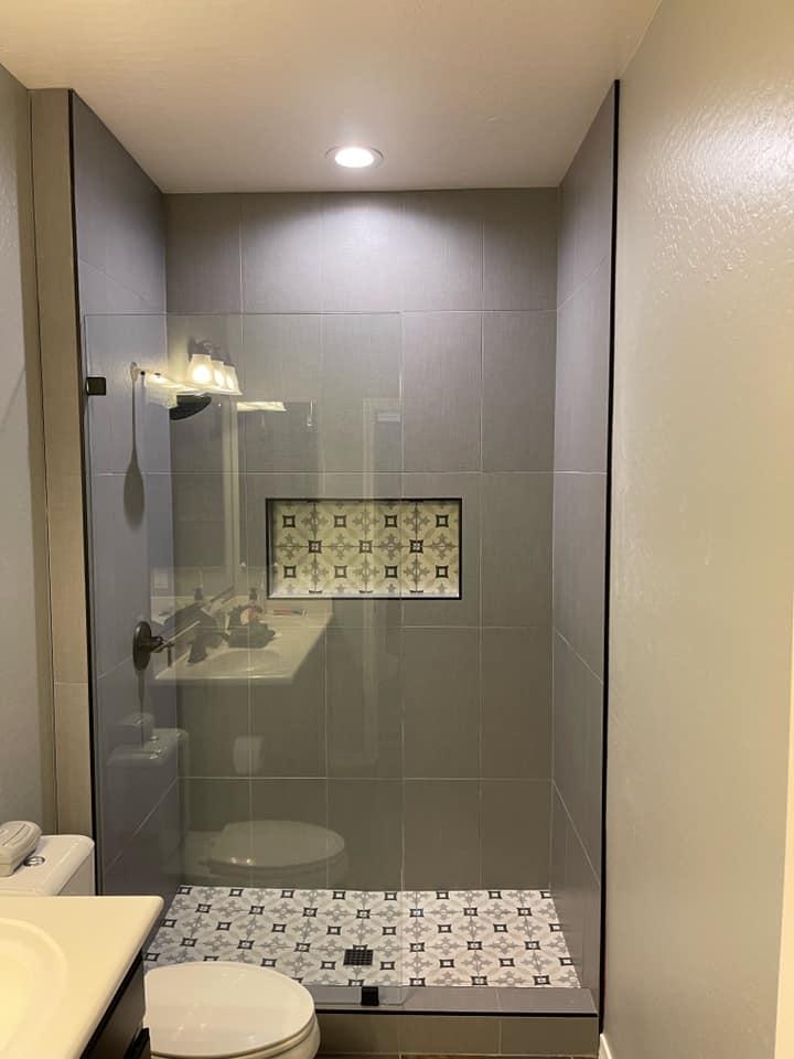 Custom walk-in shower installation with premium tile and glass enclosure